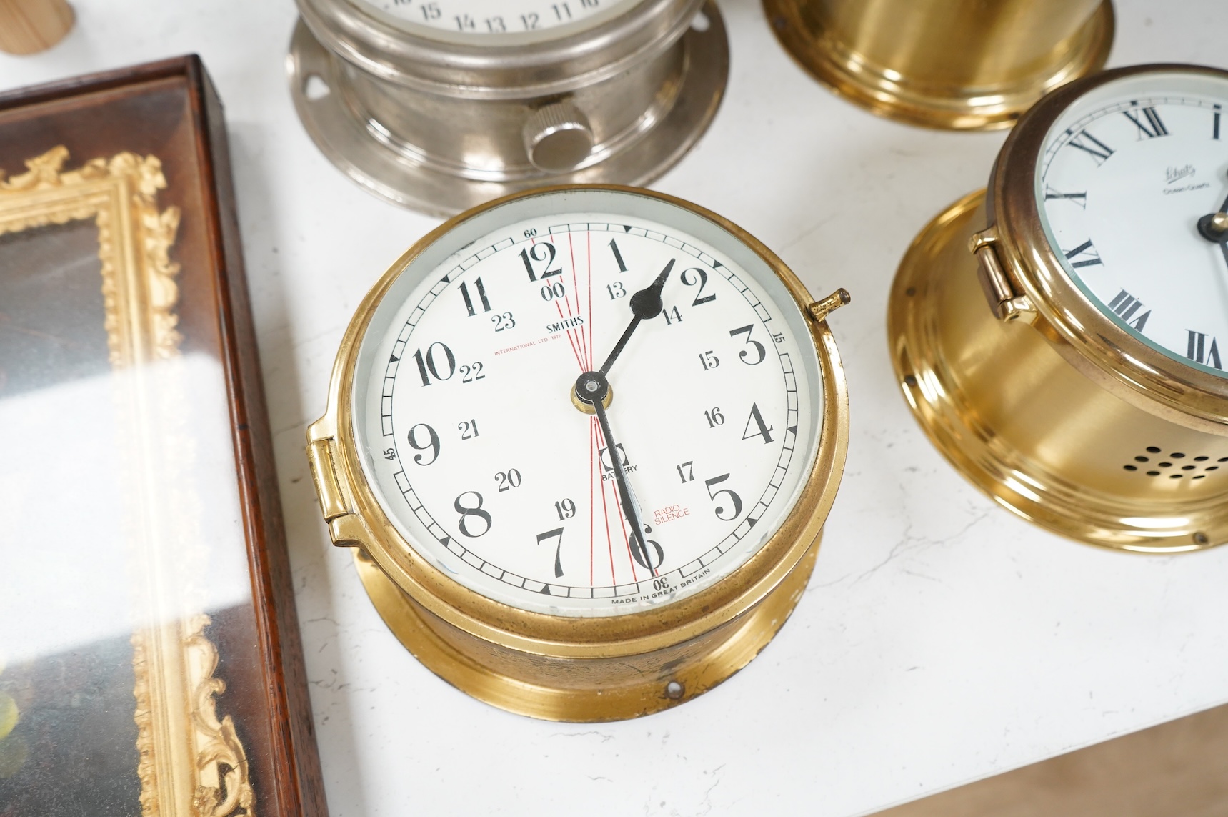 A ship's clock by Story of Barrow, a CCCP ship's clock and four other brass examples, some with keys, largest 28cm in diameter